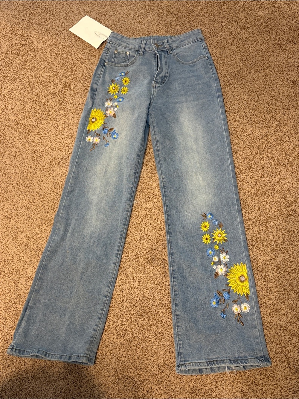 NWT denim jeans with embroidery. Size small. Waist measures stretch to 14 in